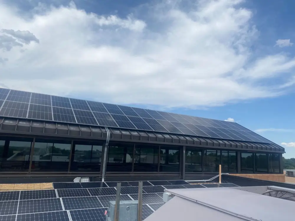 Commercial rooftop solar panels in Denver with bright sky
