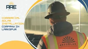 Commercial solar technician inspecting solar panels at a Larkspur business site