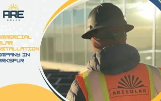 Commercial solar technician inspecting solar panels at a Larkspur business site