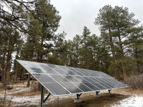 Ground-mounted solar panel system in Denver forested property