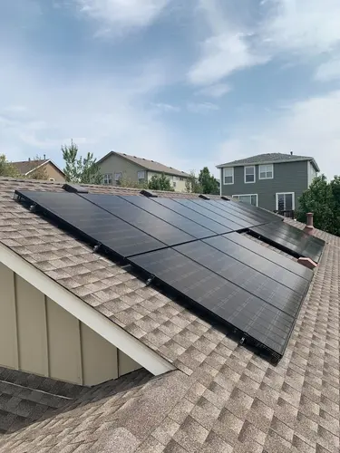 Modern solar panel array on a suburban roof near Denver, installed by ARE Solar for maximum energy efficiency