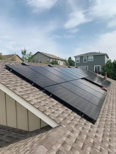 Rooftop solar panels installed on a modern suburban home, maximizing sun exposure for energy efficiency